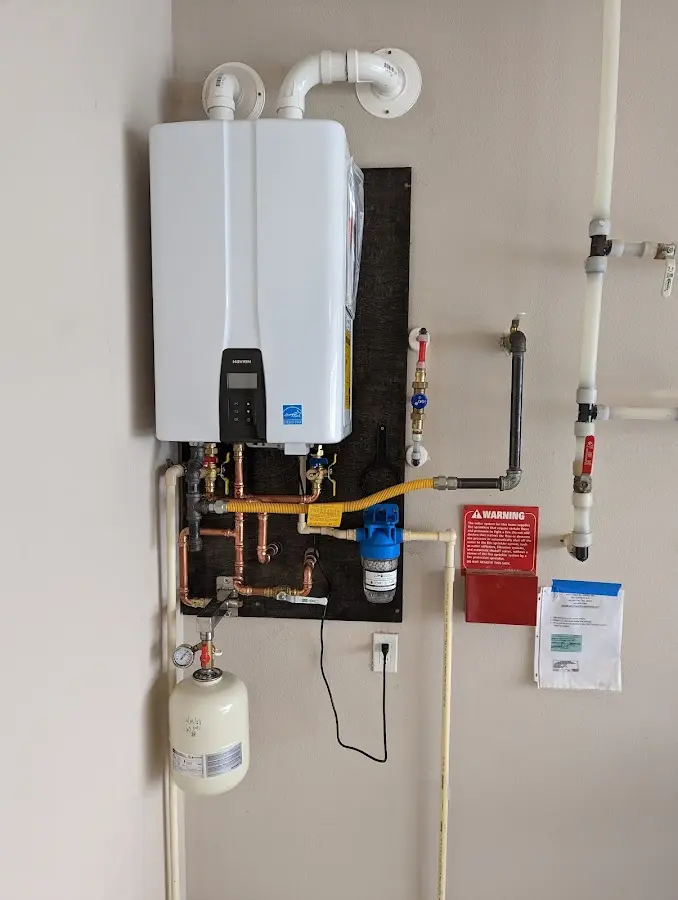 Professional plumber installing copper piping in a Cherry Creek home